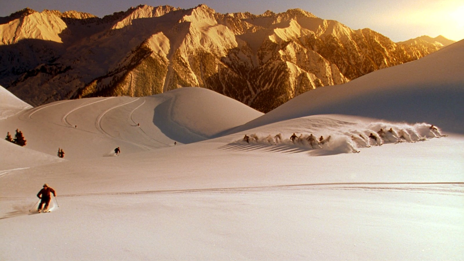 Skiers in deep powder on Aspen's high bowls