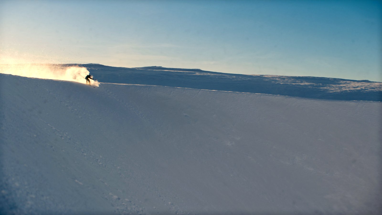 A skier dropping off the Lone Peak tram