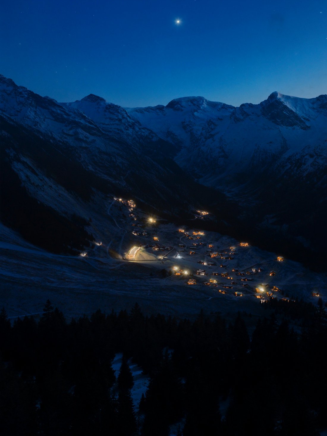 Saas-Fee village glowing at night beneath snowy peaks