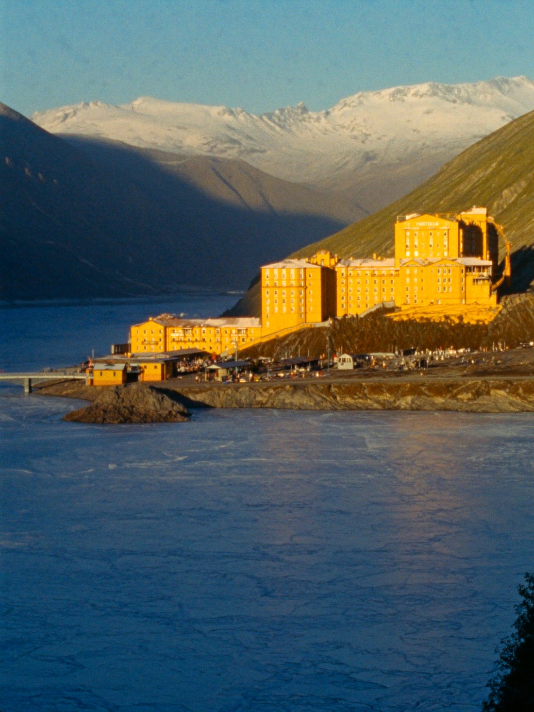 The yellow Hotel Portillo above the frozen Laguna del Inca