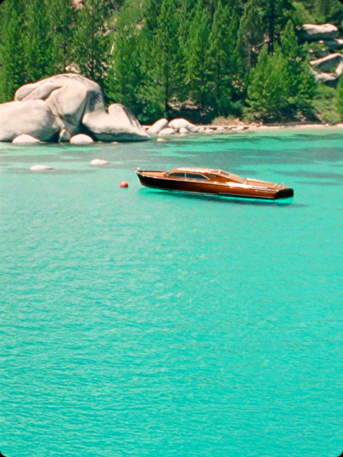 A classic wooden boat on the clear water of Lake Tahoe
