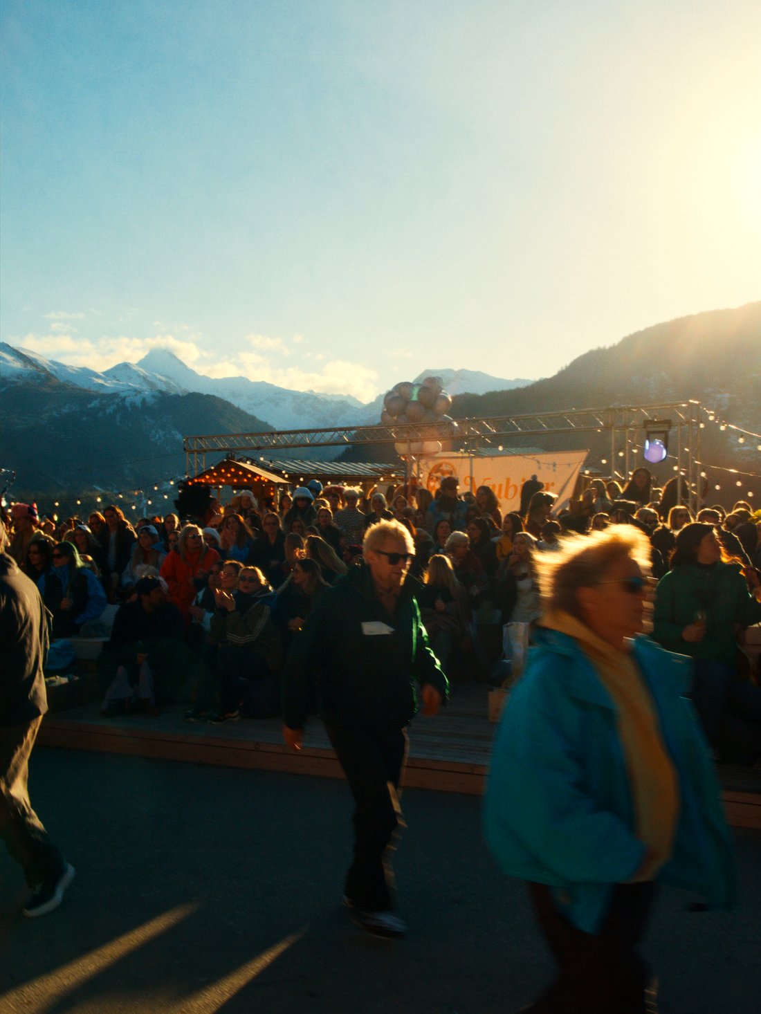 A lively Verbier après-ski terrace at golden hour